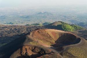 Group of tourists walking on the edge of the crater. photo