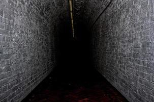 Darkened tunnel walkway photo