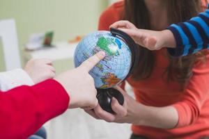 children touching globe