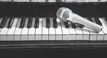 Microphone on piano keyboard. White and black. Music photo