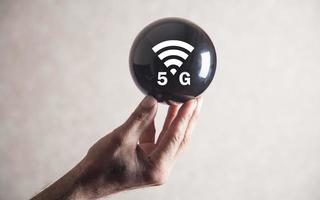 Man holding 5G network wireless systems on crystal ball. photo