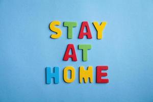 Colorful word Stay at home on the blue background. photo