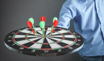 Businessman holding dart board with arrows. Target, Business, Success