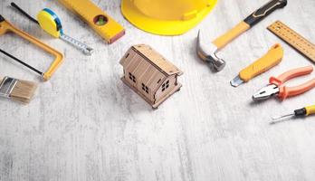 Work tools with a wooden house model. photo