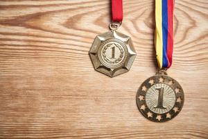 Medals awards for winner on wood background. photo