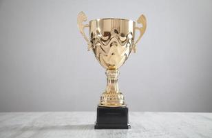 Golden trophy on white desk. Business, Success