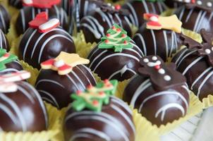 bolas de chocolate árbol de navidad muñeco de nieve ciervos. foto