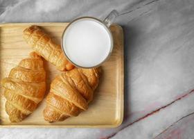 Top view Croissants and milk on marble background. photo