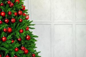 Hermoso árbol de Navidad con adornos rojos de cerca foto