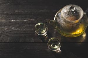 view from above of tea kettle and cup on wooden table photo