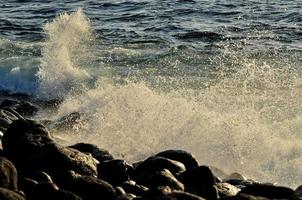 Waves crashing on rocks photo