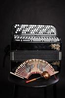 Russian folk musical instruments. Black accordion and rattles photo