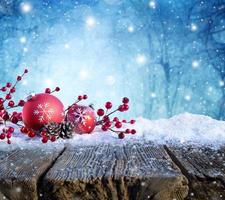 Red Christmas Ornament On Snowy Table With Snowfall On Background