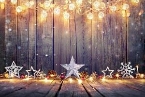 Vintage Christmas Decoration With Stars And Lights On Wooden Table photo