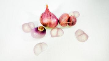 Red whole onion with cut slices isolated on a white background photo