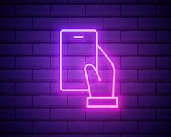 Phone in hand neon sign, modern glowing banner design, colorful trend of modern design on black background. Vector illustration isolated on brick wall background
