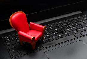 Close up mini red seat on black laptop keyboard