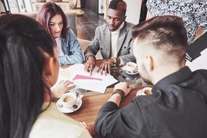 Group of casually dressed businesspeople discussing ideas. Creative professionals gathered for discuss the important issues of the new successful startup project. Teamwork Brainstorming concept photo