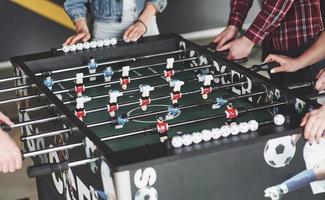 Friends together play board games, table football photo