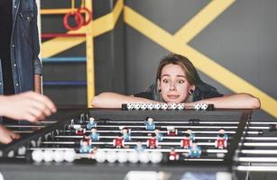 Friends together play board games, table football photo