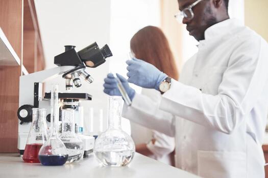 Laboratory laboratories conduct experiments in a chemical laboratory in transparent flasks. Output formulas photo