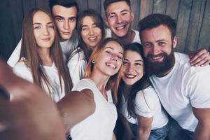 Selfie photo of young smiling teenagers having fun together