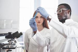 Laboratory laboratories conduct experiments in a chemical laboratory in transparent flasks. Output formulas photo