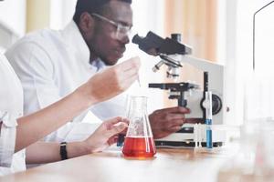 Scientists work closely with the microscope in the laboratory by conducting experiments and analyzes. photo