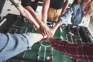 Friends together play board games, table football, have fun free time. photo