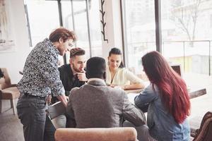 Group of casually dressed businesspeople discussing ideas. Creative professionals gathered for discuss the important issues of the new successful startup project. Teamwork Brainstorming concept photo