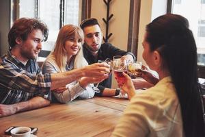 Hands of people with glasses of whiskey or wine, celebrating and toasting in honor of the wedding or other celebration photo