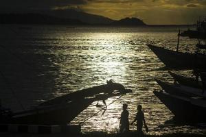 Sunset background with ships silhouette photo