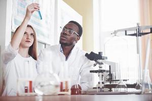 Scientists work closely with the microscope in the laboratory by conducting experiments and analyzes. photo