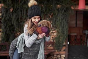 Happy young couple has fun on fresh snow at beautiful winter sunny day on vacation photo