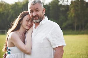 An elderly man hugged his adult daughter outdoors photo