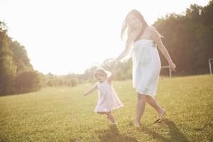 baby girl with mother on summer sunny day. photo