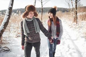 Happy Young Couple in Winter Park having fun.Family Outdoors photo
