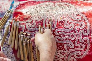 SANTA MARGHERITA LIGURE, ITALY, APRIL 29, 2017 - Unidentified woman doing pillow lace making on street of Santa Margherita Ligure. In this part traditional pillow lace was popular since 16th century photo