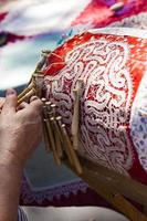 SANTA MARGHERITA LIGURE, ITALY, APRIL 29, 2017 - Unidentified woman doing pillow lace making on street of Santa Margherita Ligure. In this part traditional pillow lace was popular since 16th century photo