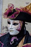 VENICE, ITALY, FEBRUARY 10, 2013 - Unidentified person with Venetian carnival mask in Venice, Italy. At 2013 it is held from January 26th to February 12th. photo