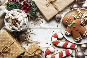 Christmas background with gift box, cocoa and gingerbread cookies.