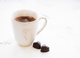 Cup of coffee and chocolate candy photo