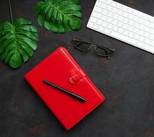 Red notebook and keyboard photo
