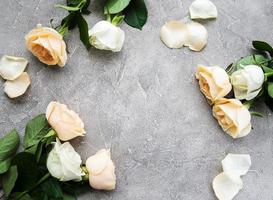 Yellow and white roses on a stone background photo