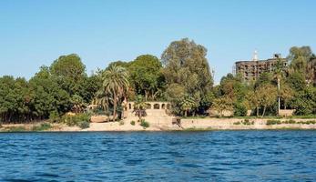 antique stone building on the banks of the Nile river photo