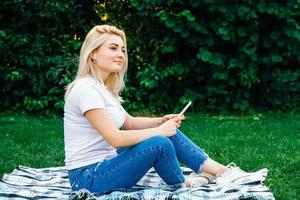 Woman in headphones and smartphone in hands photo