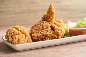 Fried chicken and potato sauce with rosemary leaf, Junk food high calorie served on white plate photo