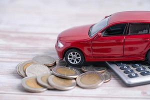 Car on stack of coins. Car loan, Finance, saving money, insurance and leasing time concepts. photo