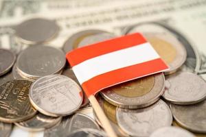 Stack of coins with Austria flag on US dollar banknote. photo