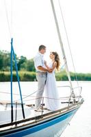 young couple guy and girl on a sailing yacht photo